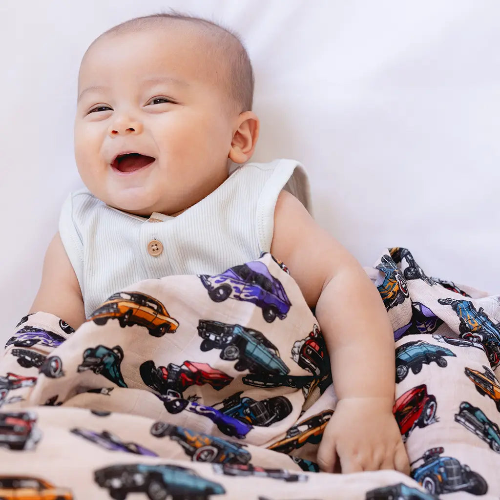Boys nursery bedding set with swaddles, blankets, and crib sheets in matching prints and colors.