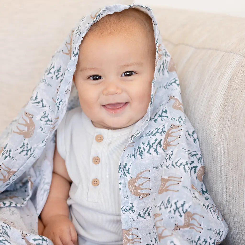 Blitzen cotton muslin baby swaddle blanket in the deer and snowflake Christmas print