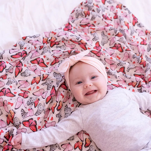 Cynthia butterfly print muslin baby swaddle blanket in vibrant pink, girls nursery