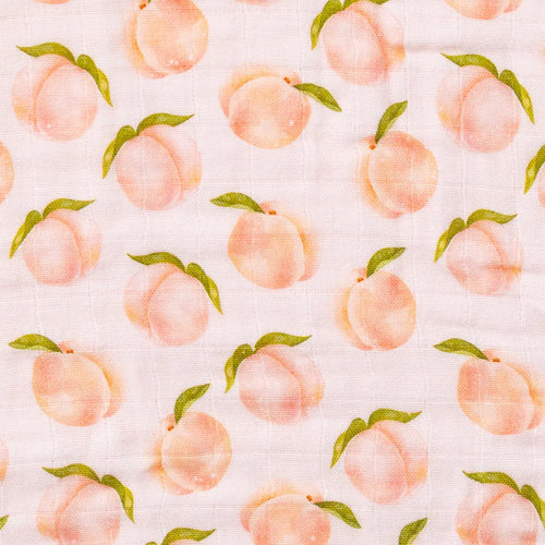 Close-up of Georgia Peach watercolor print on organic muslin fabric, soft peach and cream tones