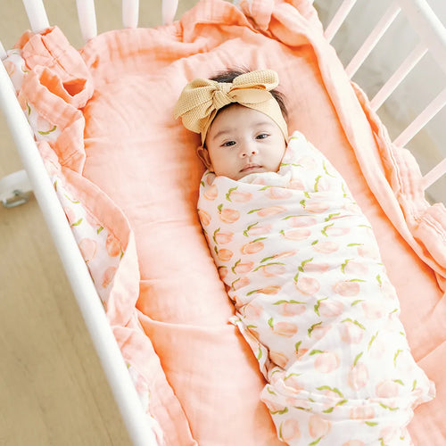 Georgia Peach watercolor print muslin baby swaddle blanket in soft peach and cream tones
