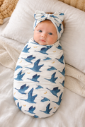 Newborn baby girl in Gus goose print stretchy swaddle and matching headwrap, TENCEL Modal set