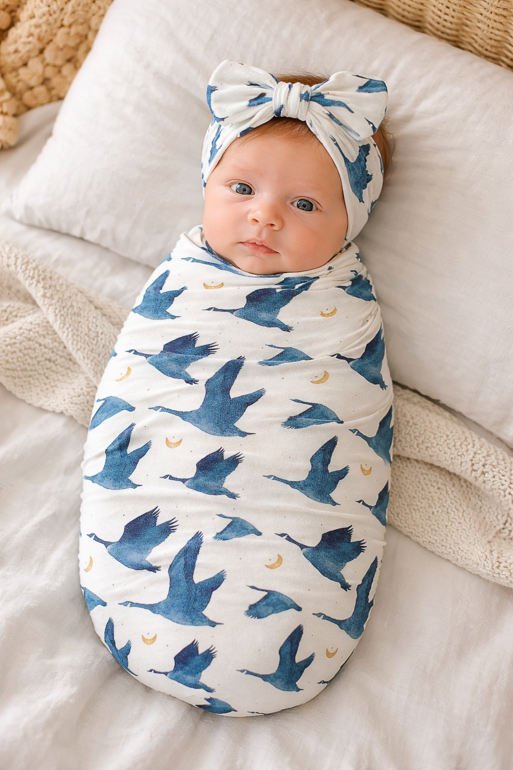 Newborn baby girl in Gus goose print stretchy swaddle and matching headwrap, TENCEL Modal set