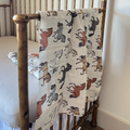 Hudson horse print swaddle folded showing the soft organic muslin texture